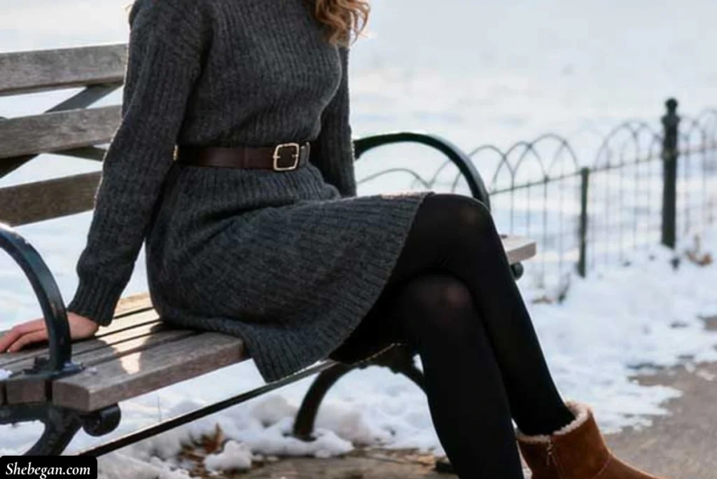 A woman sitting wearing Dress Over Leggings With Boots