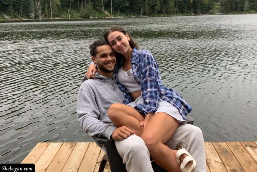 A lady sitting on a guy's lap